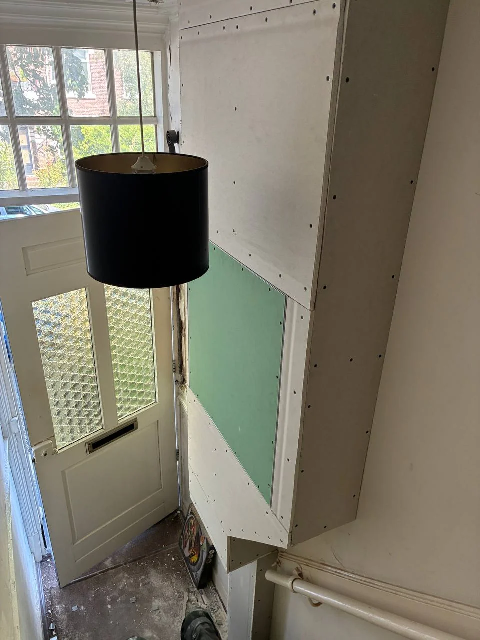 Plasterboard lining wall in an entrance during installation